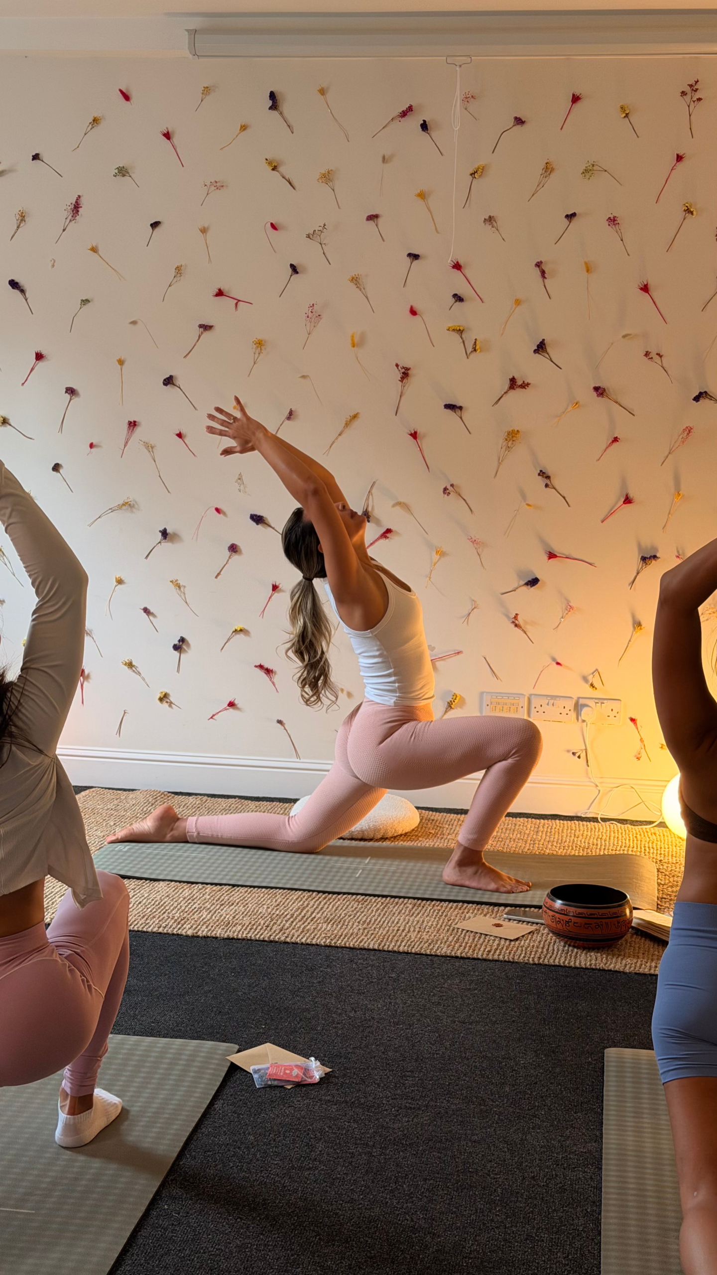 Lua guiding a Yoga class with students in Dublin